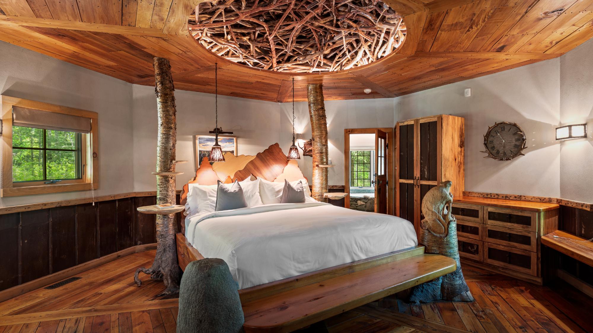 Interior of the rustic Beaver Cottage at Winvian Farm with a wooden bed