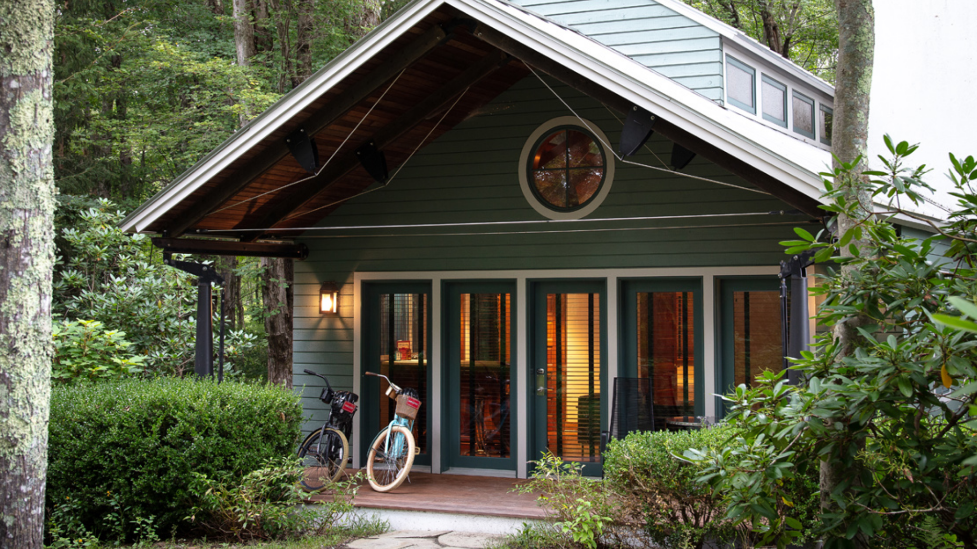 Exterior of the Maritime Cottage at Winvian Farm with bicycles on the porch.