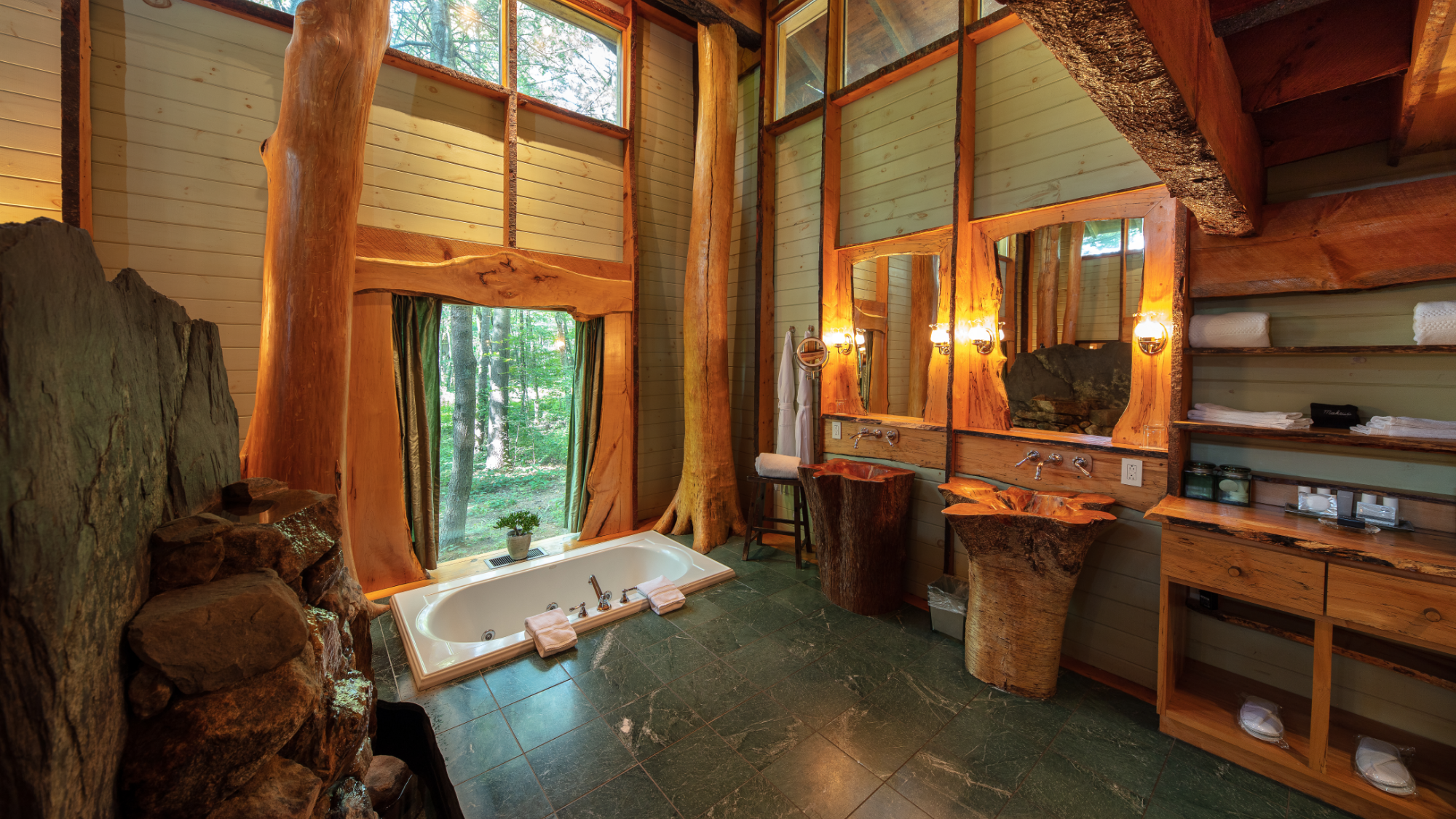 Luxurious bathroom with natural wood decor and large windows at Winvian Farm.
