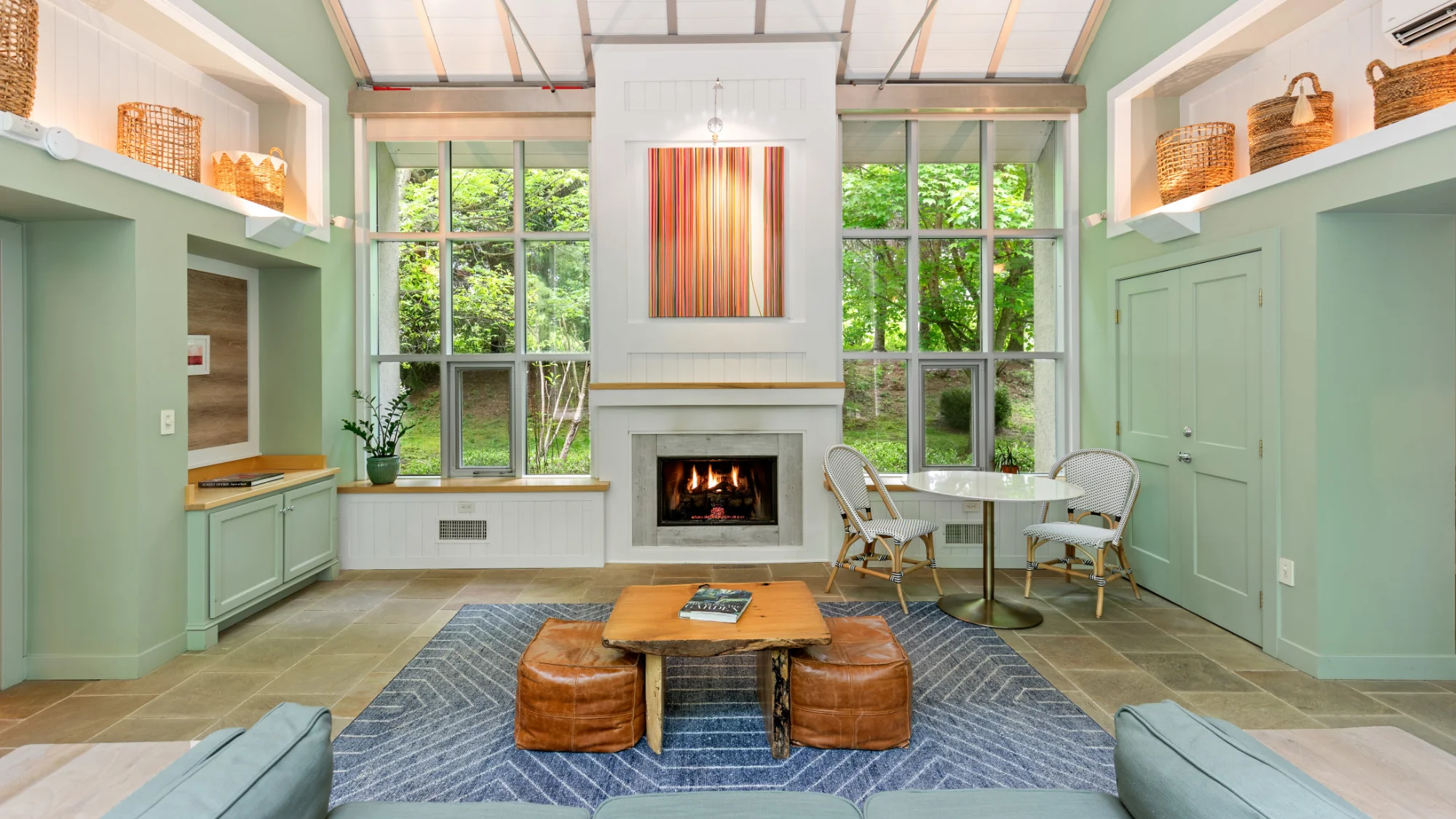Bright living area with a fireplace and large windows at Winvian Farm.