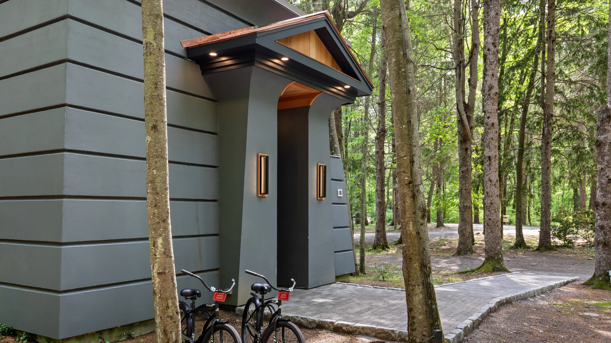Exterior of the modern Industry Cottage at Winvian Farm with bicycles at the entrance.