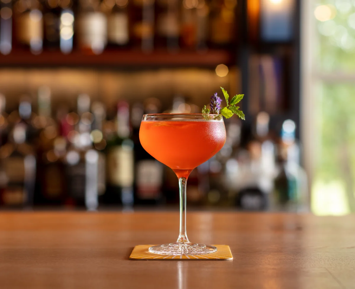 Colorful cocktail garnished with herbs at the bar in Winvian Farm.