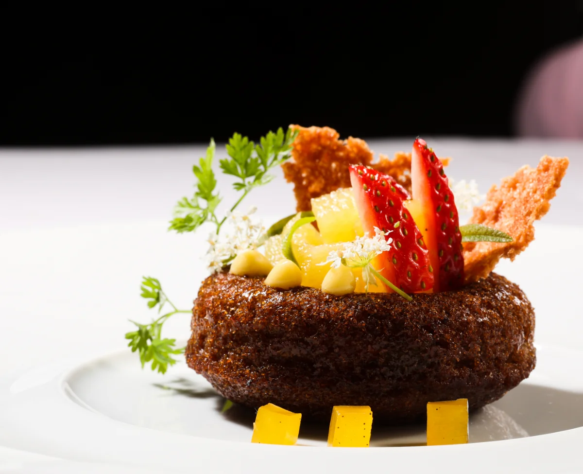 Gourmet dessert garnished with strawberries and herbs at Winvian Farm.