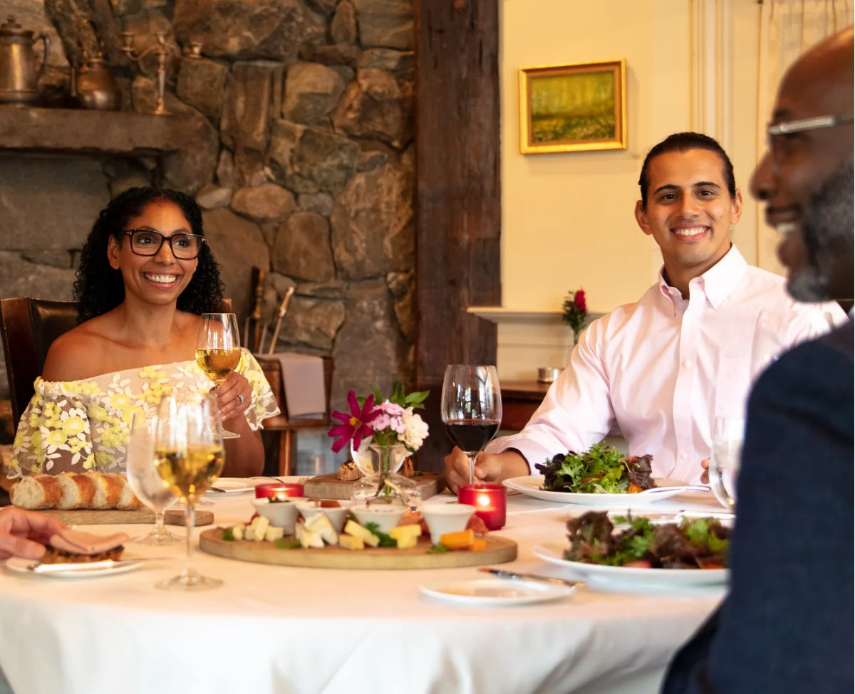 Group of friends dining and enjoying wine at Winvian Farm.