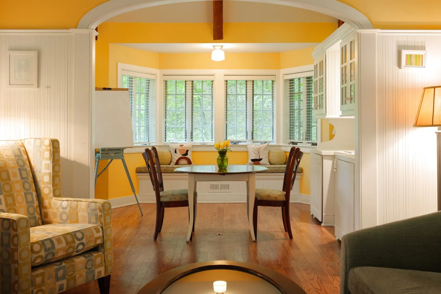 Cozy room with yellow walls and seating area.
